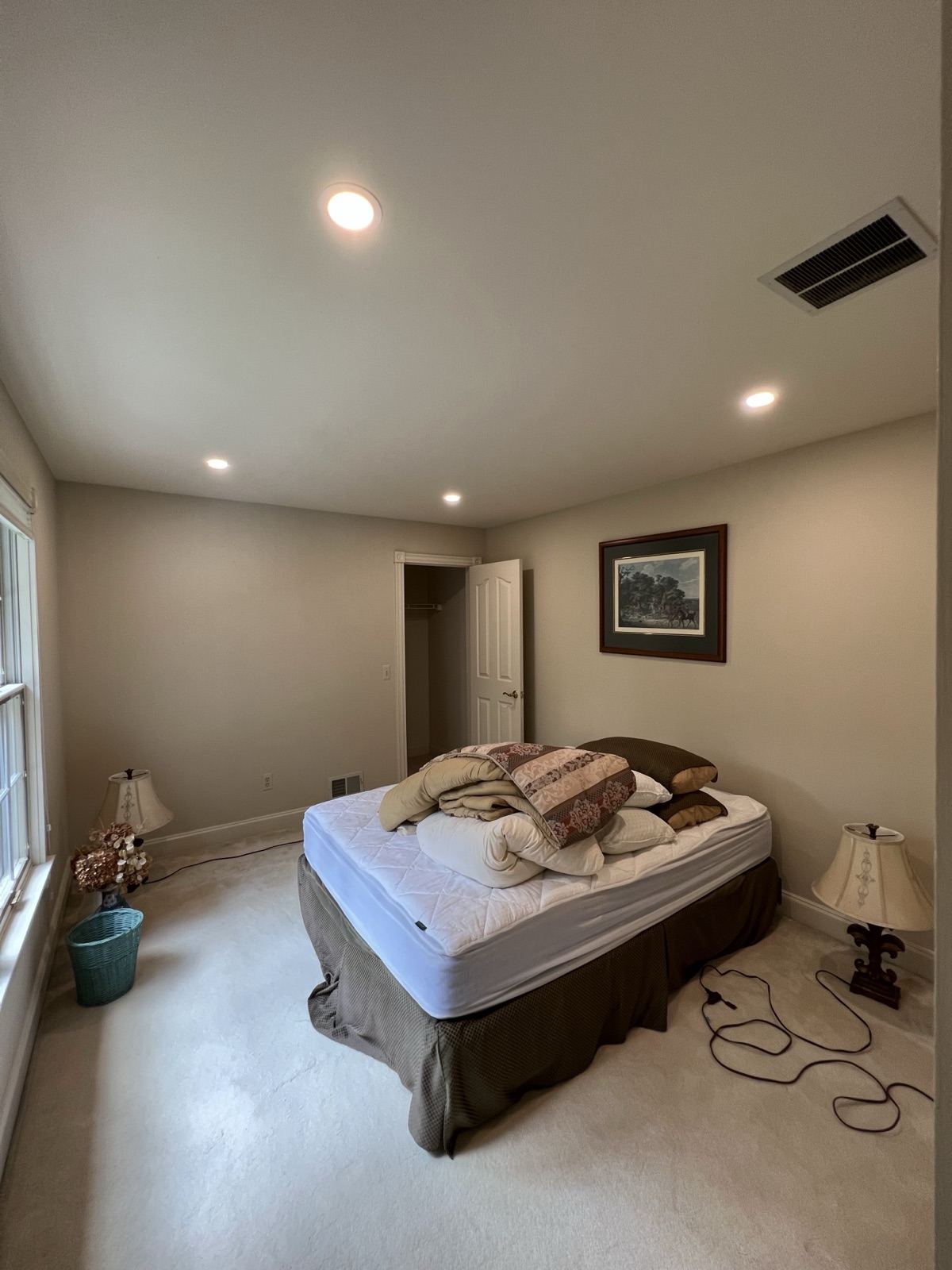 Evenly spaced recessed LED lights in a finished bedroom