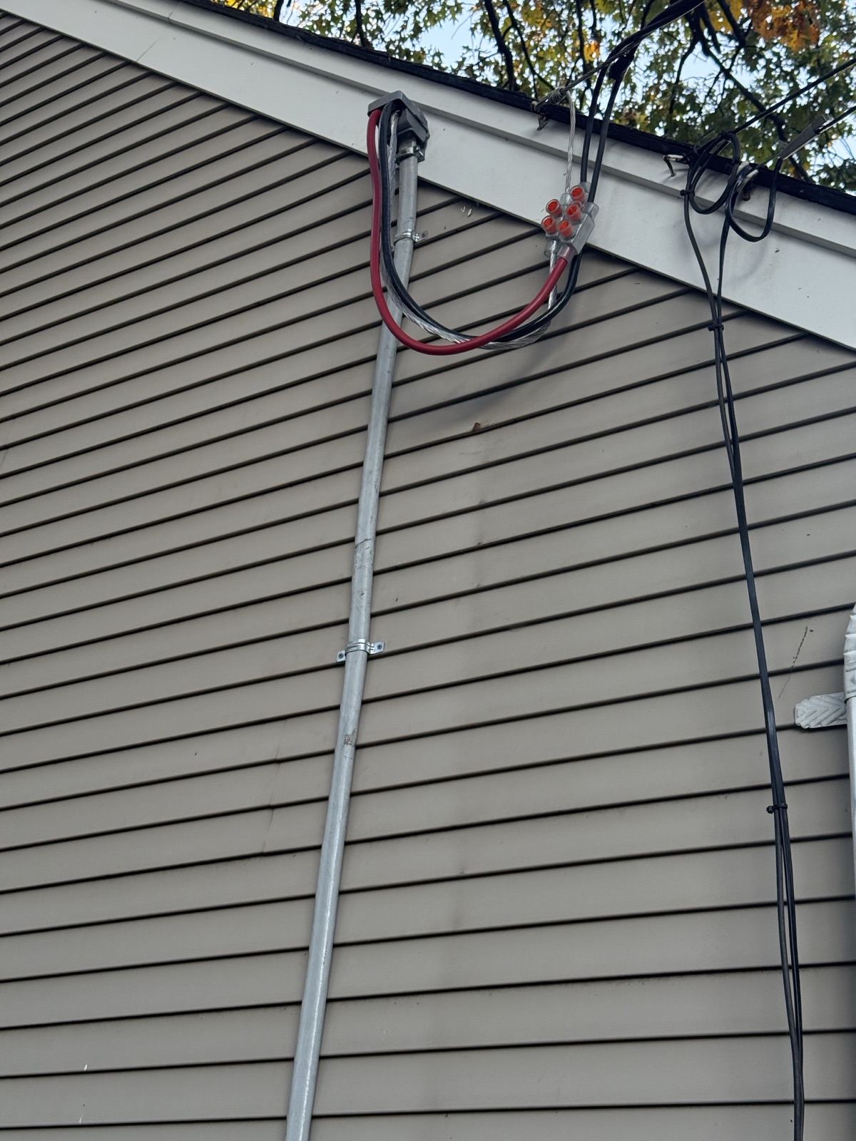 Replaced service entrance cable and weatherhead after storm damage