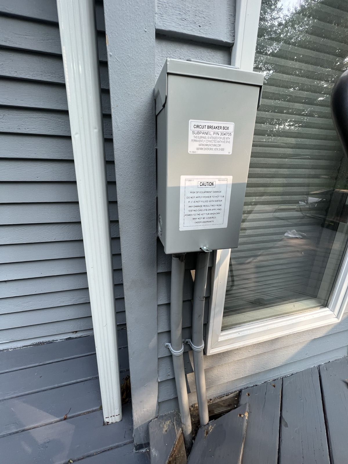 Spa disconnect box installed at code distance from a hot tub